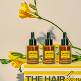 THREE PACK: 3 Hair Boomer con gotero sobre caja decorativa y flores amarillas, tratamiento capilar para fortalecer y hacer crecer el cabello.